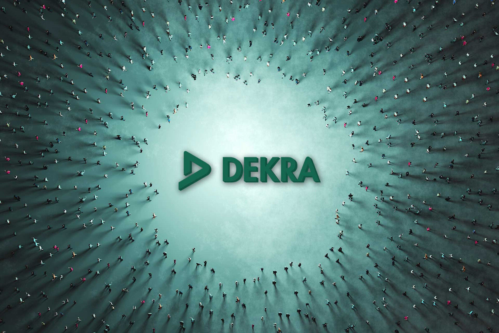 A huge DEKRA logo lies on the ground. People are streaming towards the logo from all directions.